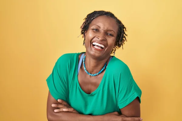 Afrykańska Kobieta Dredami Stojąca Nad Żółtym Tłem Uśmiechająca Się Śmiejąca — Zdjęcie stockowe