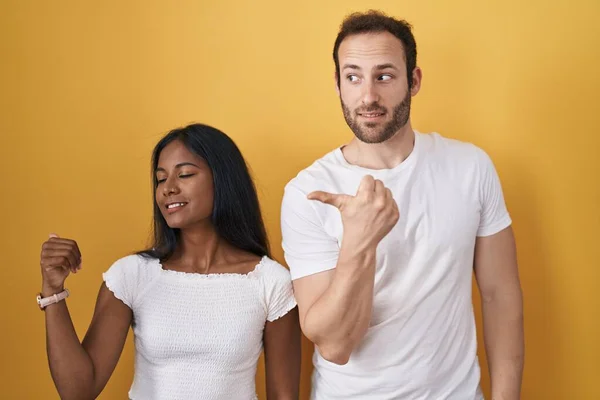 Interracial Couple Standing Yellow Background Smiling Happy Face Looking Pointing — 图库照片
