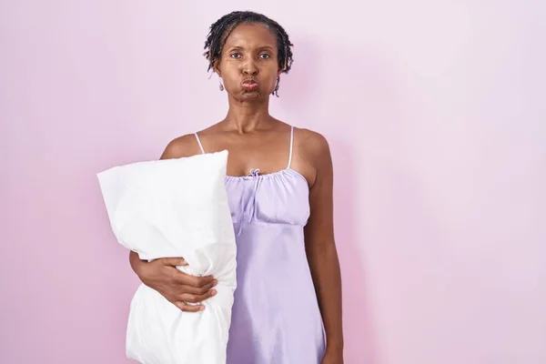 African Woman Dreadlocks Wearing Pajama Hugging Pillow Puffing Cheeks Funny — Stockfoto