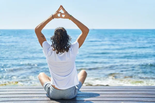 Young Hispanic Man Doing Yoga Exercise Sitting Bench Seaside — Stock fotografie