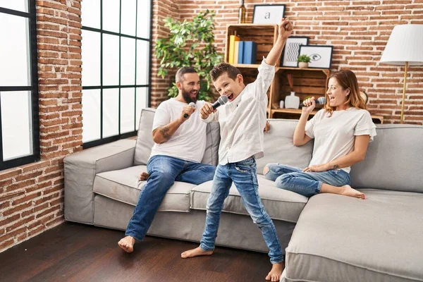 Family singing song using microphone at home