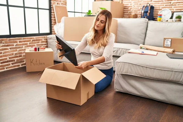 Young Blonde Woman Smiling Confident Unboxing Package New Home — ストック写真