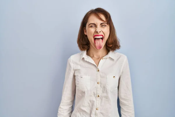 Young Beautiful Woman Standing Casual Blue Background Sticking Tongue Out — Stock Photo, Image