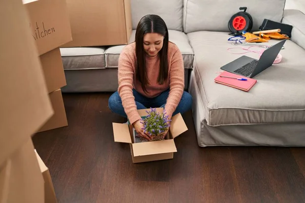 Young Hispanic Woman Unpacking Lavander Plant Cardboard Box New Home — Stockfoto