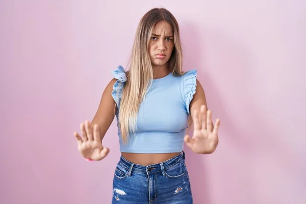 Young Blonde Woman Standing Pink Background Moving Away Hands Palms — Zdjęcie stockowe