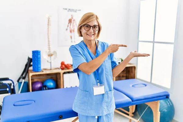 Middle Age Blonde Woman Working Pain Recovery Clinic Amazed Smiling — Stock Photo, Image