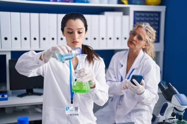 Две Женщины Учёные Используют Смартфон Измеряют Жидкость Лаборатории — стоковое фото