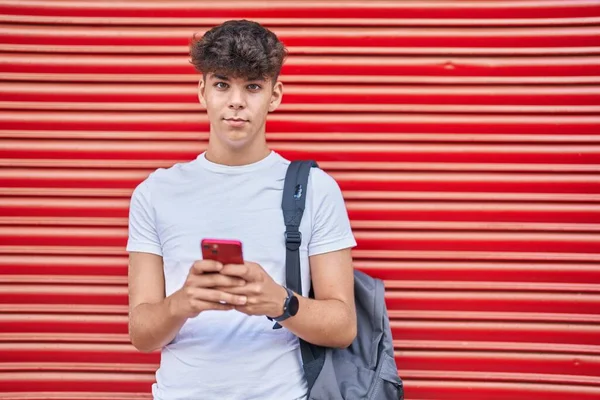 Joven Estudiante Adolescente Hispano Usando Smartphone Con Expresión Relajada Sobre —  Fotos de Stock