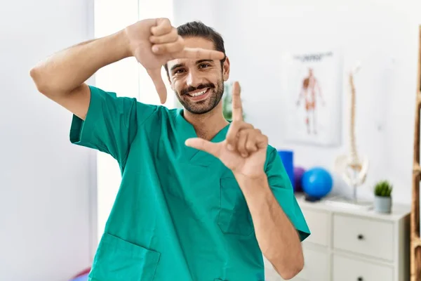 Young Physiotherapist Working Pain Recovery Clinic Smiling Making Frame Hands — Stok fotoğraf