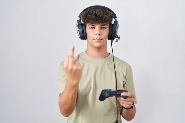 Hispanic Teenager Playing Video Game Holding Controller Showing Middle Finger — Stockfoto