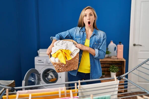 Junge Blonde Frau Mit Wäschekorb Verängstigt Und Schockiert Mit Überraschung — Stockfoto