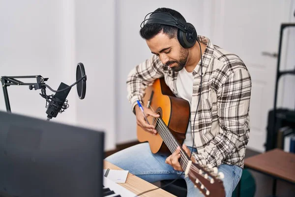 Young Hispanic Man Artist Composing Song Playing Guitar Music Studio — Fotografia de Stock