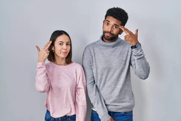 Young Hispanic Couple Standing Together Shooting Killing Oneself Pointing Hand — Stok fotoğraf