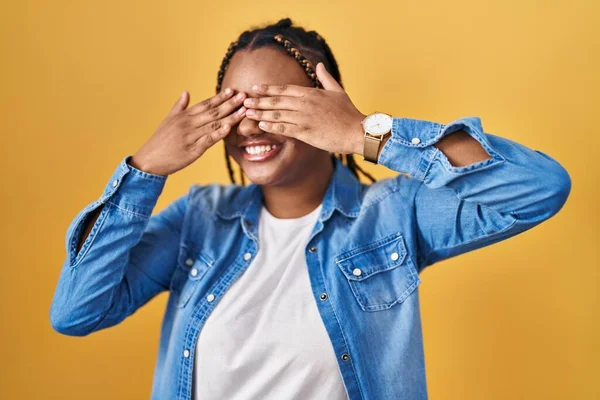 African American Woman Braids Standing Yellow Background Covering Eyes Hands — Foto Stock