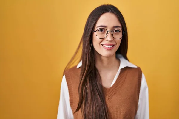 Jovem Morena Sobre Fundo Amarelo Usando Óculos Com Sorriso Feliz — Fotografia de Stock