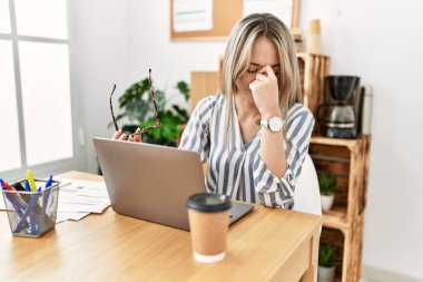 Young chinese woman stressed working at office