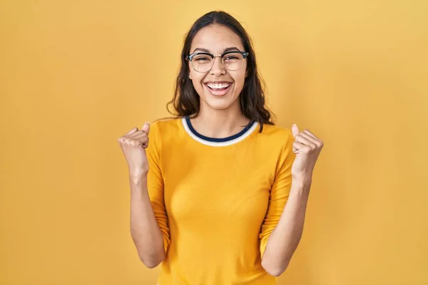 Young Brazilian Woman Wearing Glasses Yellow Background Screaming Proud Celebrating — Stock Photo, Image