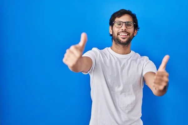 Handsome Latin Man Standing Blue Background Approving Doing Positive Gesture — Stockfoto