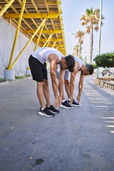 Two Hispanic Men Couple Stretching Street — Zdjęcie stockowe