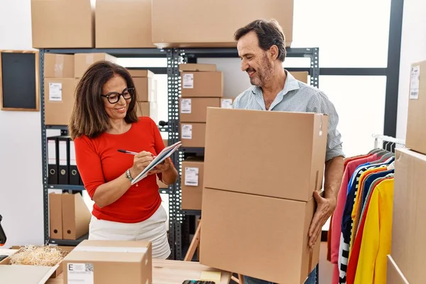 Middle Age Man Woman Business Partners Holding Packages Writing Notebook — Stock fotografie