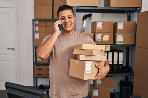 Jovem Latino Homem Ecommerce Empresário Falando Smartphones Segurando Pacotes Escritório — Fotografia de Stock