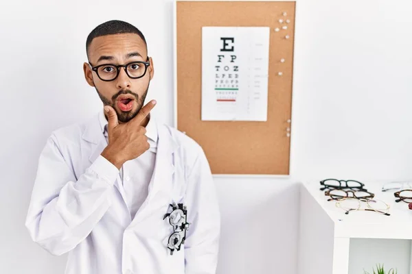 African American Optician Man Standing Eyesight Test Looking Fascinated Disbelief — Zdjęcie stockowe