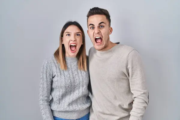 Young Hispanic Couple Standing White Background Angry Mad Screaming Frustrated — Stockfoto