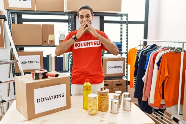 Young Hispanic Man Wearing Volunteer Shirt Donations Stand Laughing Embarrassed — Stock Photo, Image