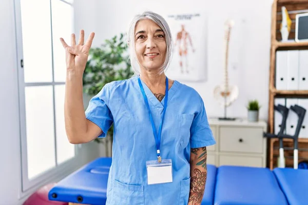 Middle Age Grey Haired Woman Wearing Physiotherapist Uniform Medical Clinic — Stock Photo, Image