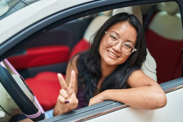 Young Chinese Woman Driving Car Doing Victory Gesture Fingers Street — 스톡 사진