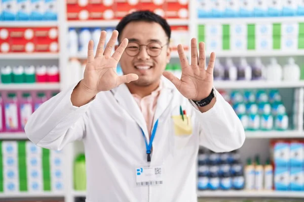 Chinese Young Man Working Pharmacy Drugstore Showing Pointing Fingers Number — Stock Photo, Image