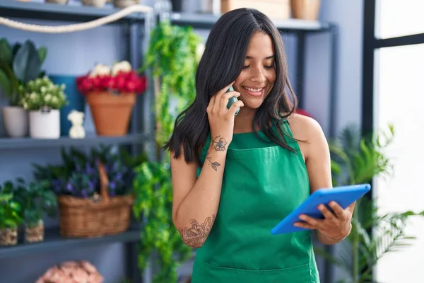 Young Hispanic Woman Florist Talking Smartphone Using Touchpad Florist Shop — Zdjęcie stockowe