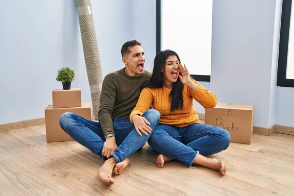 Young Couple Sitting Floor New Home Shouting Screaming Loud Side — Stock Photo, Image