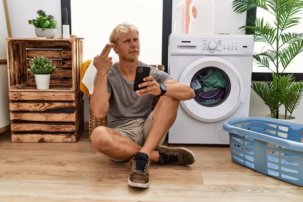 Young Blond Man Doing Laundry Using Smartphone Shooting Killing Oneself — Stok fotoğraf