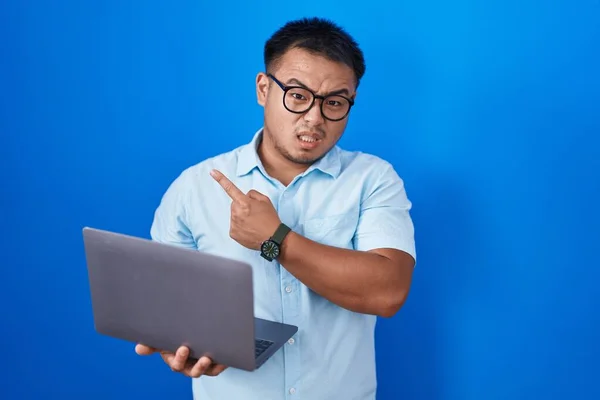 Chinese Young Man Using Computer Laptop Pointing Aside Worried Nervous — Stok fotoğraf