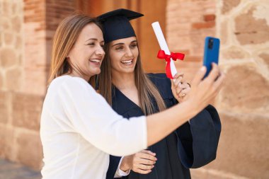 Two women mother and graduated daughter having video call at campus university