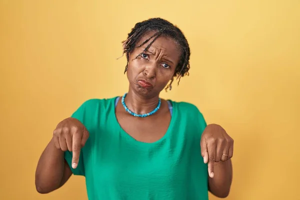 African Woman Dreadlocks Standing Yellow Background Pointing Looking Sad Upset — Stok fotoğraf