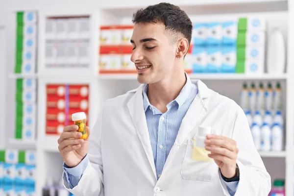 Young Hispanic Man Pharmacist Holding Pills Bottles Pharmacy —  Fotos de Stock