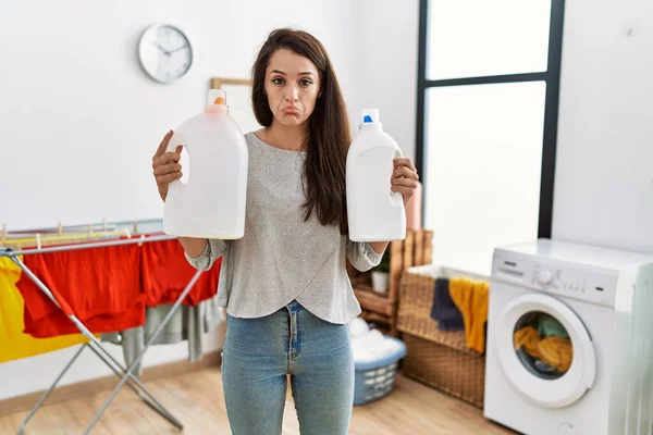 Young Brunette Woman Holding Detergent Bottle Laundry Room Depressed Worry — Stock Photo, Image