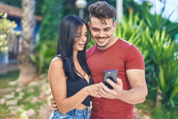 Man Woman Couple Smiling Confident Using Smartphone Park —  Fotos de Stock