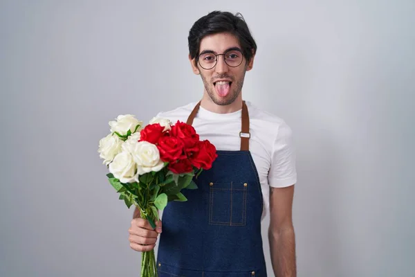 Young Hispanic Man Holding Bouquet White Red Roses Sticking Tongue — Stockfoto