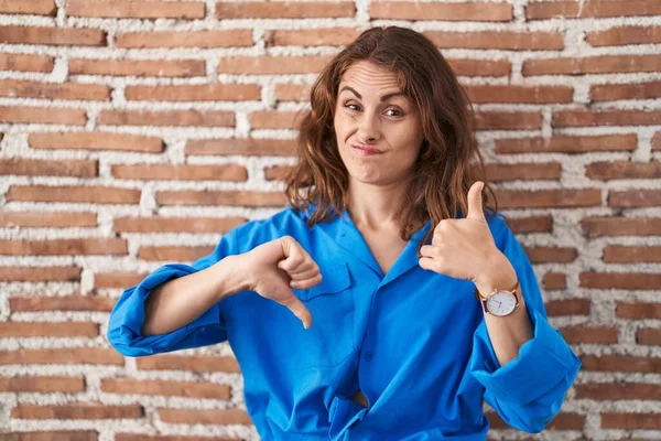 Beautiful Brunette Woman Standing Bricks Wall Doing Thumbs Disagreement Agreement — Stock Photo, Image