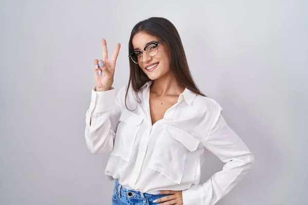 Young Brunette Woman Wearing Glasses Smiling Looking Camera Showing Fingers —  Fotos de Stock