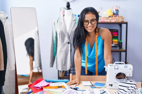 Young beautiful latin woman tailor smiling confident standing at florist