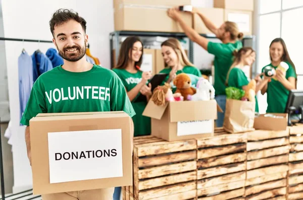 Group Young Volunteers Working Charity Center Man Smiling Happy Holding — Foto de Stock