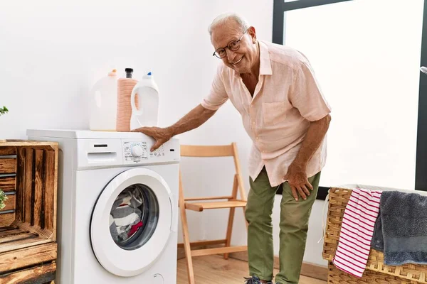 Senior Man Turning Washing Machine Laundry Room — Stockfoto