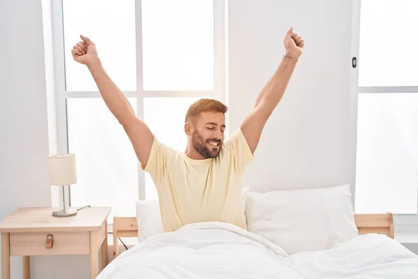Young Hispanic Man Waking Stretching Arms Bedroom — Foto Stock