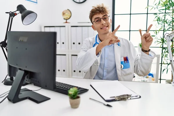 Young Caucasian Doctor Man Working Clinic Smiling Looking Camera Pointing — Stok fotoğraf