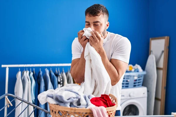 Young Hispanic Man Smelling Towel Hanging Clothes Clothesline Laundry Room —  Fotos de Stock