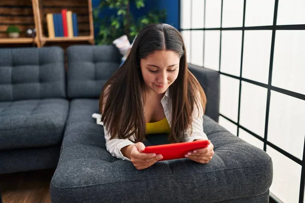 Young Hispanic Woman Using Touchpad Lying Sofa Home — Stockfoto